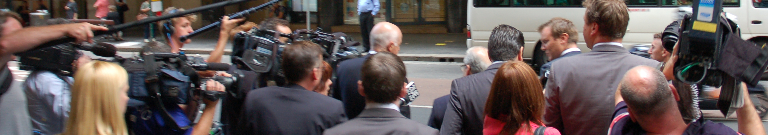 press surrounding witnesses leaving a public inquiry