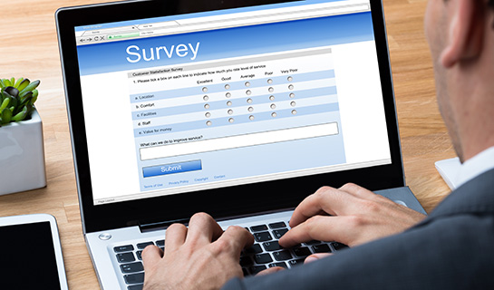 person completing survey on laptop