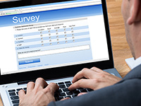 person completing online survey on a laptop